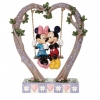 Mickey and Minnie Mouse figurine in the cradle