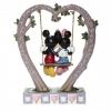 Mickey and Minnie Mouse figurine in the cradle