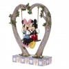 Mickey and Minnie Mouse figurine in the cradle