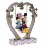 Mickey and Minnie Mouse figurine in the cradle