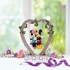 Mickey and Minnie Mouse figurine in the cradle